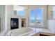 This luxury bathroom features a fireplace, tub, and serene ocean views at 770 N Manasota Key Rd, Englewood, FL 34223