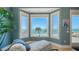 This ocean view from the bay window features a comfortable chaise lounge, blue walls, and a decorative painting at 770 N Manasota Key Rd, Englewood, FL 34223