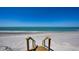 Private beach access with wooden stairs leading to the ocean and sandy beach at 770 N Manasota Key Rd, Englewood, FL 34223