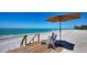 Charming beachside deck with seating and umbrella overlooking the tranquil ocean at 770 N Manasota Key Rd, Englewood, FL 34223