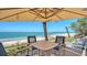 Outdoor seating offers stunning beach views in this charming coastal property at 770 N Manasota Key Rd, Englewood, FL 34223