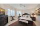 Charming bedroom with plush bedding, decorative rug, and ample natural light from the large windows at 770 N Manasota Key Rd, Englewood, FL 34223