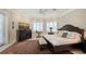 Charming bedroom with plush bedding, decorative rug, and ample natural light from the large windows at 770 N Manasota Key Rd, Englewood, FL 34223