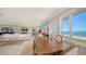 Open-concept dining room boasting waterfront views and an adjacent living area at 770 N Manasota Key Rd, Englewood, FL 34223