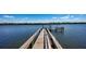 Scenic view down the private wooden dock leading to the waterfront at 770 N Manasota Key Rd, Englewood, FL 34223