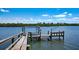 Private dock with boat lift and seating overlooking tranquil waterfront views at 770 N Manasota Key Rd, Englewood, FL 34223