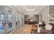 Inviting foyer with multiple seating areas, access to waterfront deck, and staircase at 770 N Manasota Key Rd, Englewood, FL 34223