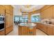 Custom kitchen showcases modern appliances, an island, and a breakfast bar all with breathtaking ocean views at 770 N Manasota Key Rd, Englewood, FL 34223