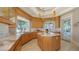 Gourmet kitchen with a hexagonal island, pendant lighting, and abundant counter space near bright windows at 770 N Manasota Key Rd, Englewood, FL 34223