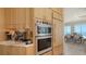 Modern kitchen featuring stainless steel appliances, custom cabinetry, and a coffee station, all with ocean views at 770 N Manasota Key Rd, Englewood, FL 34223