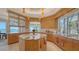 Gourmet kitchen boasts custom cabinets, a center island, and stunning ocean views from the large window at 770 N Manasota Key Rd, Englewood, FL 34223