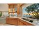 Kitchen features a sink with a view of the ocean, custom cabinetry, and an adjacent breakfast nook at 770 N Manasota Key Rd, Englewood, FL 34223