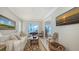 Comfortable living room with waterfront views and an adjacent room with a piano at 770 N Manasota Key Rd, Englewood, FL 34223