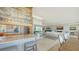 Bright open floor plan seamlessly connects the kitchen, living area, and dining space with elegant, neutral decor at 770 N Manasota Key Rd, Englewood, FL 34223