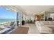 Open-concept living and dining area with seamless access to a beachfront deck and endless ocean views at 770 N Manasota Key Rd, Englewood, FL 34223