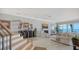 Relaxing living area with a fireplace and access to an outside deck and waterfront at 770 N Manasota Key Rd, Englewood, FL 34223