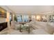 Bright living room features a cozy fireplace and expansive windows with breathtaking ocean views at 770 N Manasota Key Rd, Englewood, FL 34223