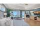 This well-lit bedroom has water views, a fireplace, and a sitting area with a chaise lounge at 770 N Manasota Key Rd, Englewood, FL 34223
