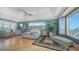This bedroom has an ocean view, ceiling fan, seating area, and light wood floors at 770 N Manasota Key Rd, Englewood, FL 34223