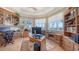 Inviting home office space featuring custom wood cabinets, hardwood floors, and large windows providing plenty of natural light at 770 N Manasota Key Rd, Englewood, FL 34223