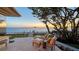 Coastal home's patio offers stunning ocean view with lounge seating and lush tropical landscaping at 770 N Manasota Key Rd, Englewood, FL 34223