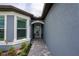Inviting front entryway with a decorative glass door and a pathway of pavers at 9263 Barrier Coast Trl, Parrish, FL 34219