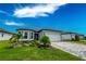 Charming one-story home with a two car garage, brick paver driveway, lush landscaping, and a well maintained lawn at 9263 Barrier Coast Trl, Parrish, FL 34219