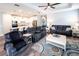 Cozy living room with comfortable seating, ceiling fan, and an open view to the kitchen at 9263 Barrier Coast Trl, Parrish, FL 34219