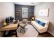 Well-lit home office space with a modern desk, comfortable seating, and stylish decor at 9263 Barrier Coast Trl, Parrish, FL 34219
