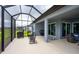 Spacious screened patio offers outdoor dining and lounging with beautiful lake views at 9263 Barrier Coast Trl, Parrish, FL 34219