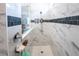 Luxurious walk-in shower featuring marble tiling with decorative accents and modern fixtures at 9263 Barrier Coast Trl, Parrish, FL 34219