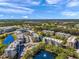Aerial view of the condo complex featuring lake views and surrounding landscaping at 960 Starkey Rd # 1503, Largo, FL 33771