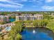 Aerial view of a condo complex featuring waterfront views and a community pool at 960 Starkey Rd # 1503, Largo, FL 33771
