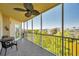 Enjoy serene water views from this screened balcony with a table and seating at 960 Starkey Rd # 1503, Largo, FL 33771