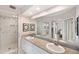 Bathroom featuring double sinks, shower with glass door, and granite countertops at 960 Starkey Rd # 1503, Largo, FL 33771