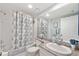 Bathroom with tub and shower combination, granite countertop, and large mirror at 960 Starkey Rd # 1503, Largo, FL 33771