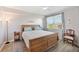Comfortable bedroom with a large window, and a wood-framed bed, and a ceiling fan at 960 Starkey Rd # 1503, Largo, FL 33771