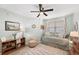 Bright bedroom features a ceiling fan, daybed, chair, and wooden shelving unit at 960 Starkey Rd # 1503, Largo, FL 33771
