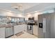 This updated kitchen features stainless steel appliances, white cabinets and granite countertops at 960 Starkey Rd # 1503, Largo, FL 33771