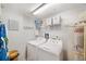 A well-lit laundry room with washer, dryer, shelving, and water heater at 960 Starkey Rd # 1503, Largo, FL 33771