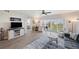 Bright living room with laminate floors, neutral walls, and balcony access overlooking the community at 960 Starkey Rd # 1503, Largo, FL 33771