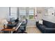 Comfortable office space with natural light, a work desk, and a loveseat at 960 Starkey Rd # 1503, Largo, FL 33771