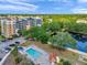 Aerial shot of the neighborhood pool offering lounge chairs and lush tropical landscaping at 960 Starkey Rd # 1503, Largo, FL 33771