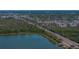Aerial view showcasing a scenic lakefront road with lush greenery, providing a tranquil living environment at 10562 Lake Dr, Seminole, FL 33772
