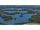 Expansive aerial view featuring a serene lake surrounded by lush mangrove islands and clear blue water at 10562 Lake Dr, Seminole, FL 33772