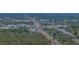 Overhead shot of a bustling commercial and residential area with tree-lined streets and vibrant activity at 10562 Lake Dr, Seminole, FL 33772