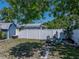Spacious backyard with stone firepit and outdoor seating surrounded by well-maintained landscaping at 10562 Lake Dr, Seminole, FL 33772