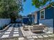 Home's backyard featuring a patio with stepping stones and an outdoor seating area at 10562 Lake Dr, Seminole, FL 33772
