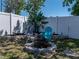 Backyard seating area around a fire pit and manicured flower beds at 10562 Lake Dr, Seminole, FL 33772