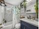 Well-lit bathroom featuring new fixtures, storage, and luxury vinyl tile flooring at 10562 Lake Dr, Seminole, FL 33772